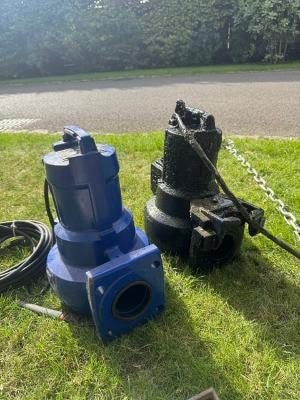 Submersible sewage pumps on grass ready for installation