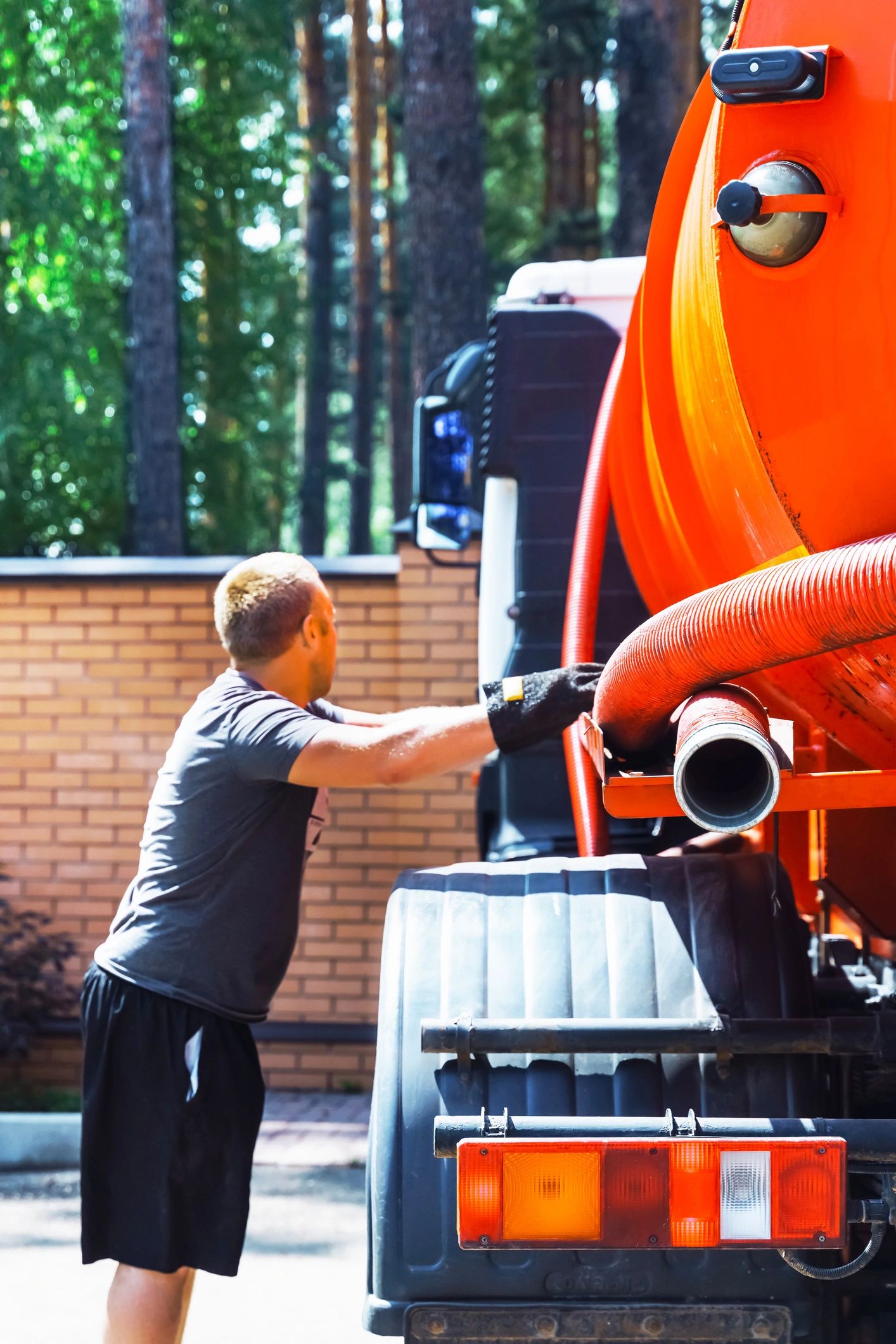Worker operating industrial vacuum truck
